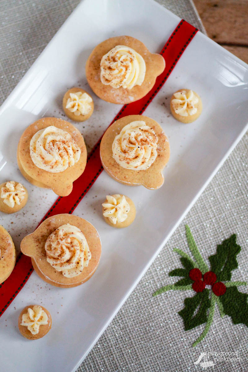 A bundle of holiday flavors wrapped up into one cookie in this festive, Christmas twist on a traditional sugar cookie! Eggnog, nutmeg and bourbon cream are sure to please your tastebuds from Christmas through the New Year! | Cookies | Christmas Cookies | Holiday Baking | Recipe | Eggnog |
